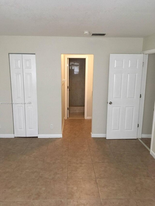 unfurnished bedroom with tile patterned floors