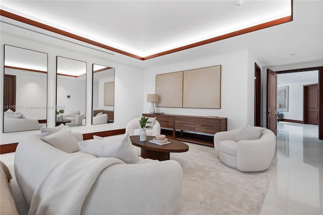 tiled living room with a raised ceiling