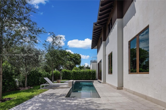 view of swimming pool with a patio area