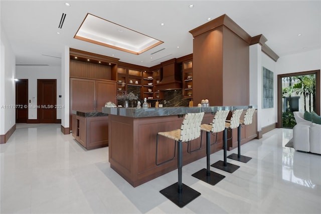 kitchen featuring backsplash and a kitchen bar