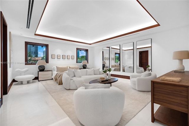 tiled living room featuring a tray ceiling