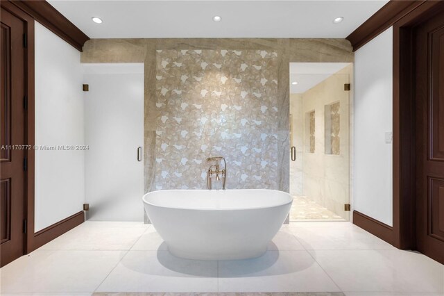 bathroom featuring separate shower and tub, tile walls, and tile patterned floors