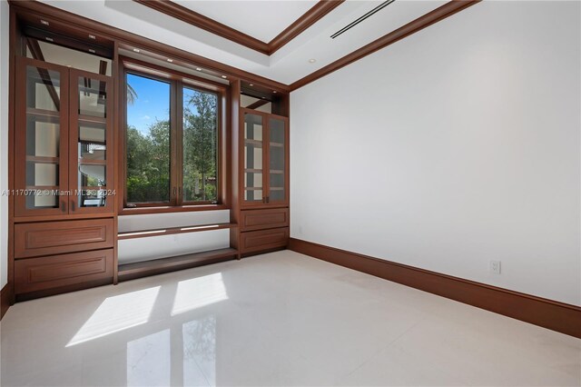 empty room featuring crown molding