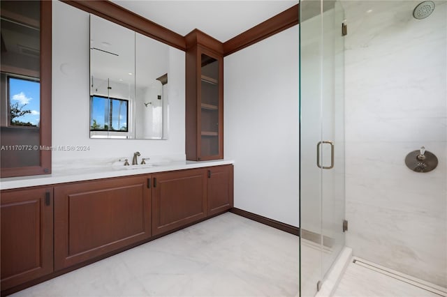 bathroom with a shower with door and vanity