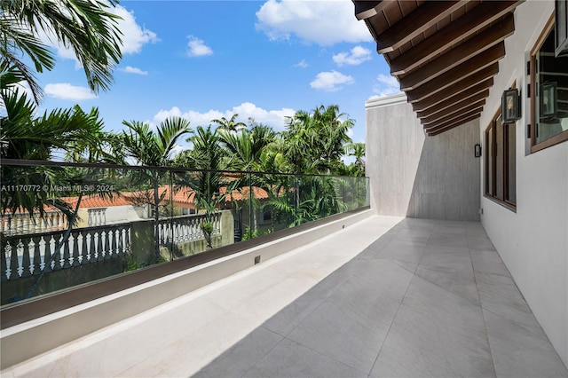 view of patio featuring a balcony and a water view