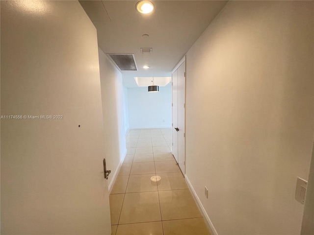 hallway featuring light tile floors