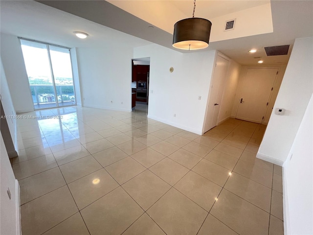 tiled empty room with a wall of windows