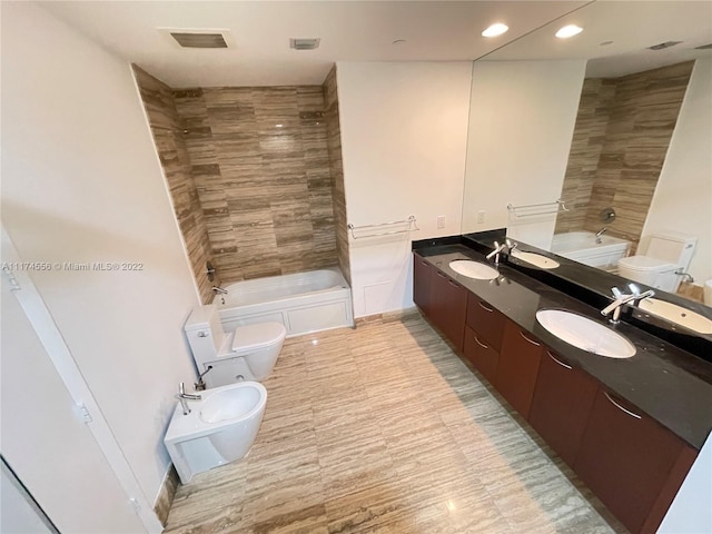 full bathroom featuring double sink vanity, tile floors, toilet, and tiled shower / bath