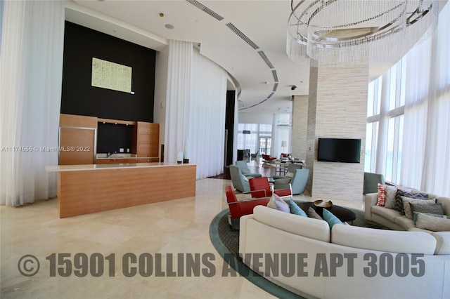 living room featuring light tile floors and a high ceiling