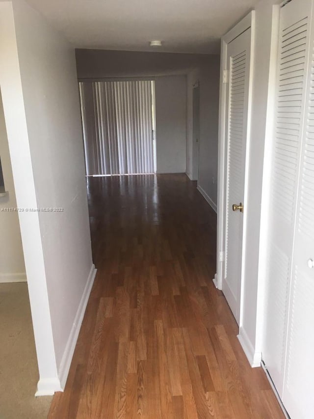 hallway with wood-type flooring