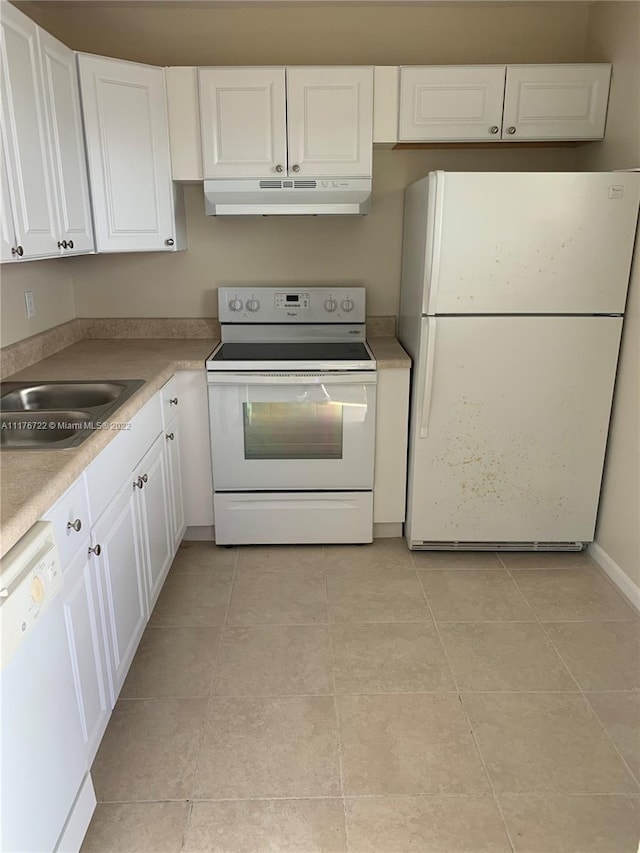 kitchen featuring white cabinetry, sink, light tile patterned floors, and white appliances