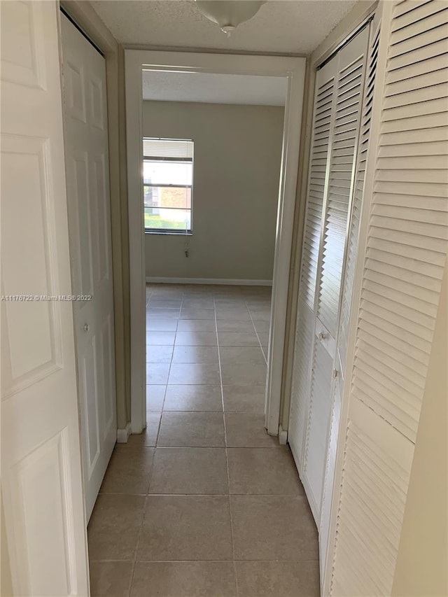 hallway with light tile patterned flooring