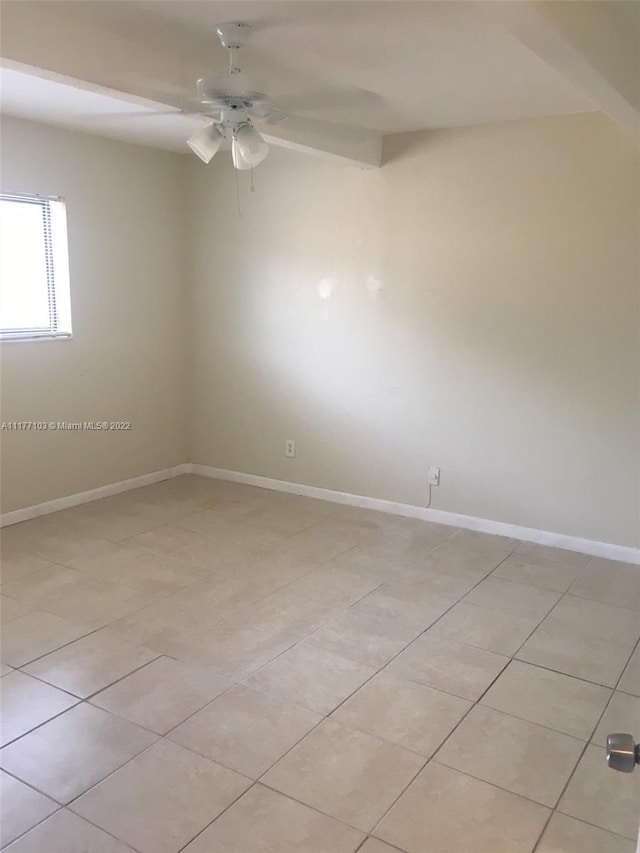 tiled empty room with ceiling fan