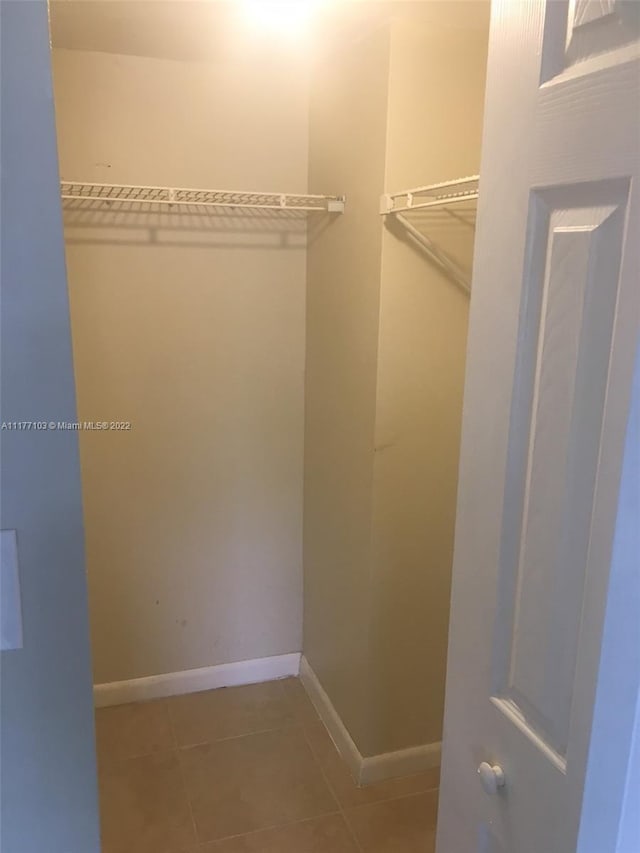 spacious closet with tile patterned flooring