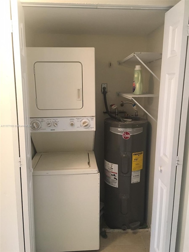 washroom with electric water heater, light tile patterned flooring, and stacked washer and clothes dryer