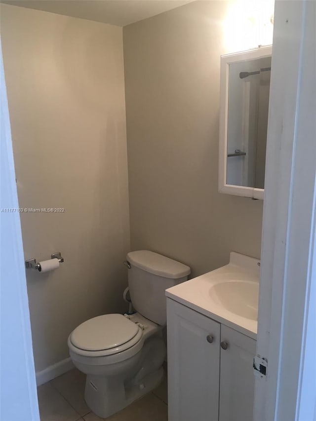 bathroom with tile patterned floors, vanity, and toilet