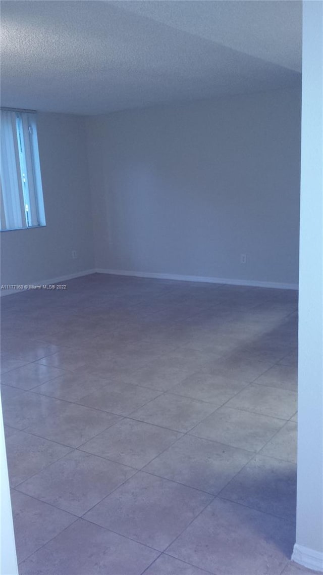 spare room with a textured ceiling