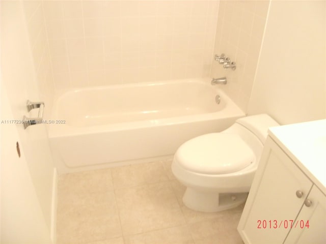 full bathroom with tile patterned flooring, vanity,  shower combination, and toilet