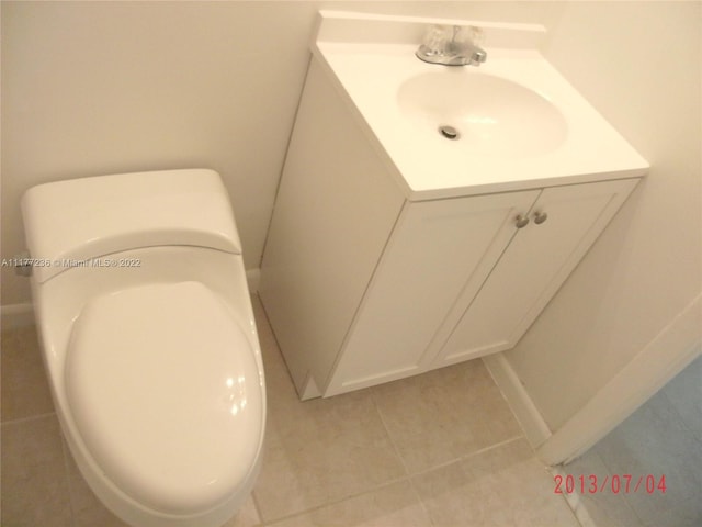 bathroom featuring tile patterned flooring, vanity, and toilet