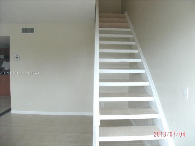 stairway featuring tile patterned floors