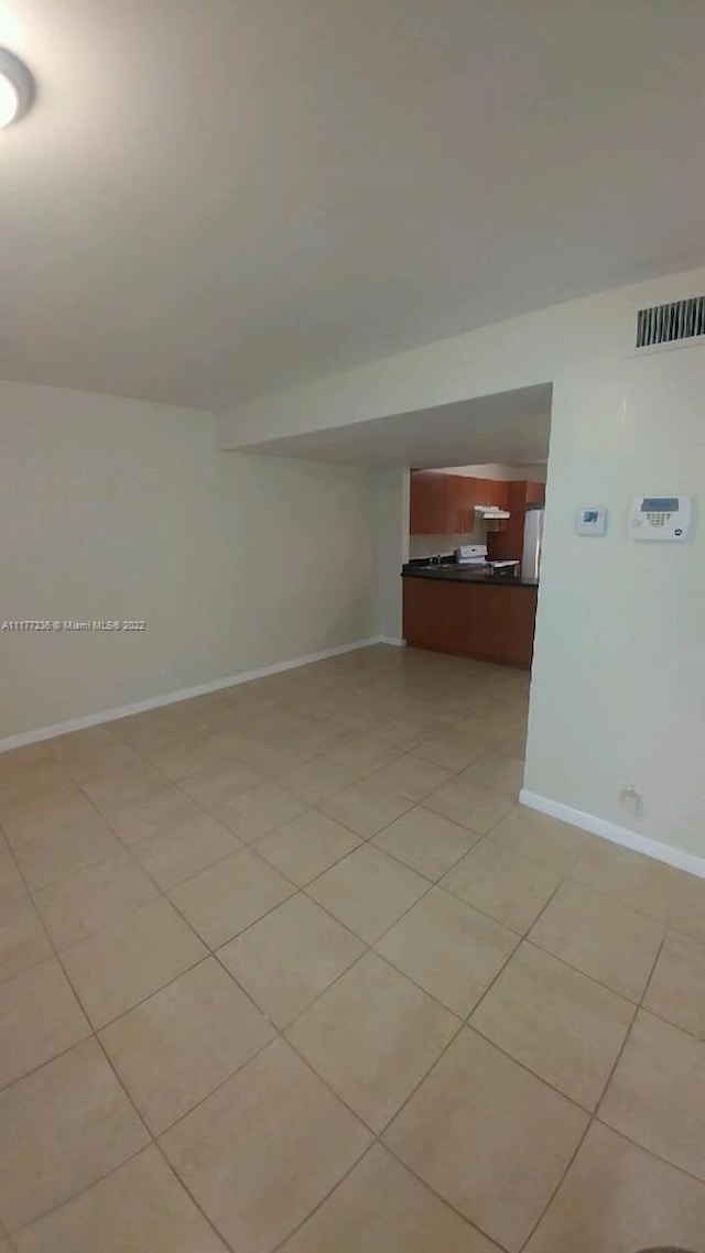 unfurnished room with light tile patterned floors