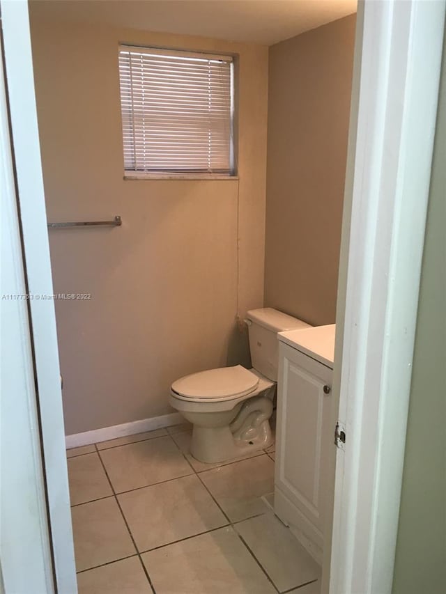 bathroom featuring toilet, vanity, and tile patterned floors