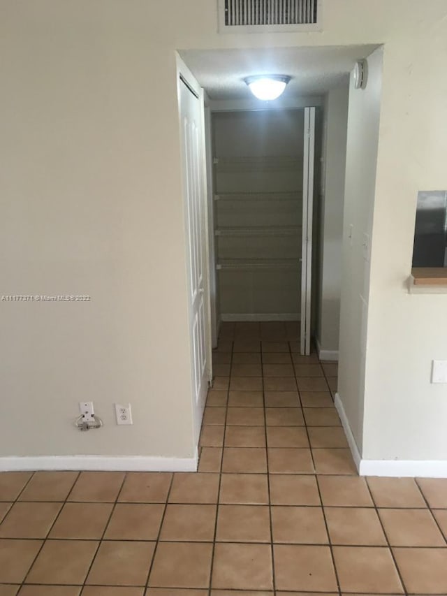 corridor with tile patterned flooring