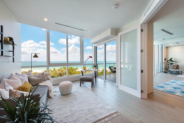 sunroom / solarium featuring a water view