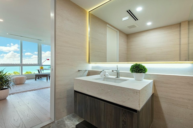 bathroom with vanity, wood-type flooring, and a water view