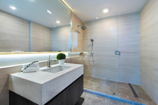 bathroom with vanity and tiled shower