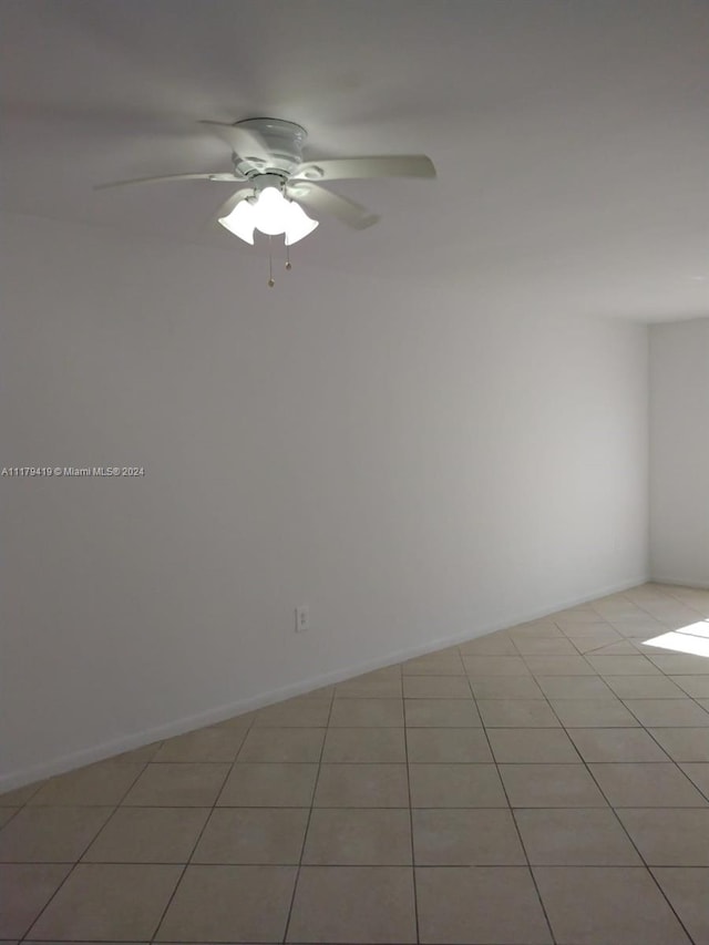 tiled empty room with ceiling fan