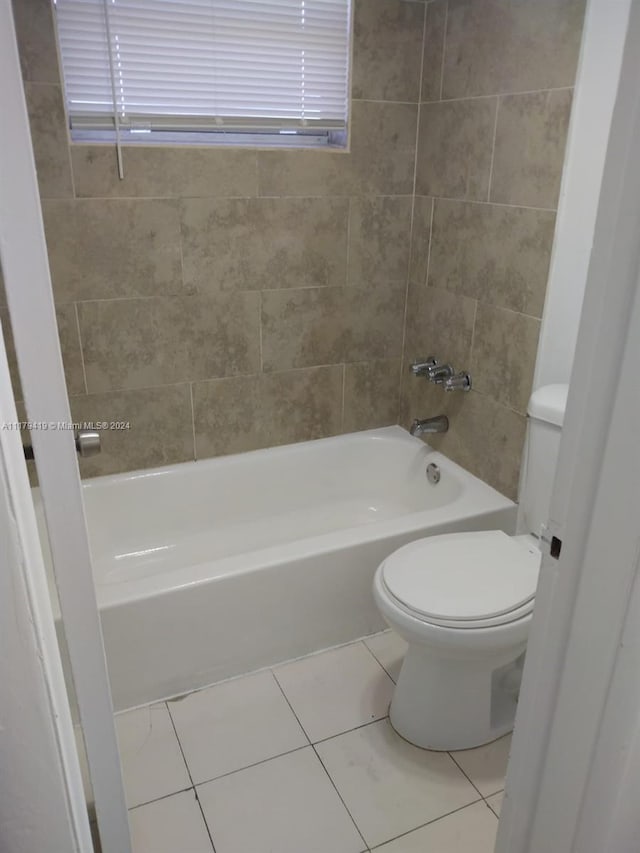 bathroom featuring tile patterned floors, toilet, and shower / bathing tub combination