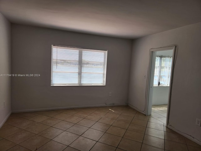 empty room with light tile patterned floors