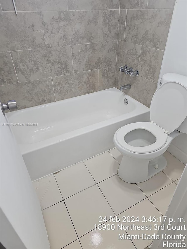 bathroom with tile patterned floors, shower / tub combination, and toilet