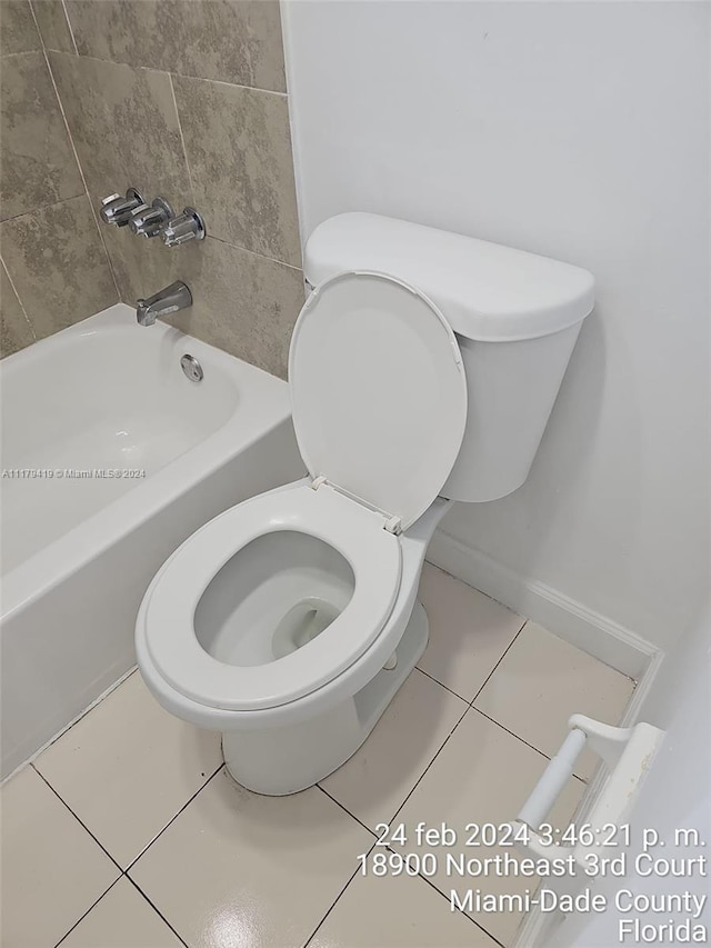 bathroom with tile patterned floors, bathtub / shower combination, and toilet