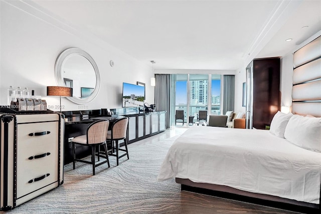 bedroom featuring expansive windows and crown molding