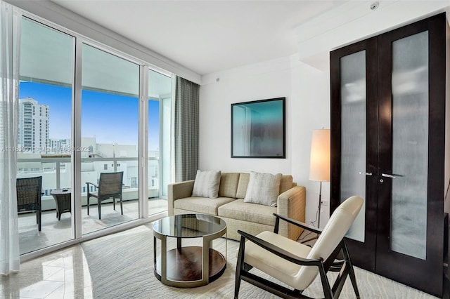 living room featuring french doors and expansive windows