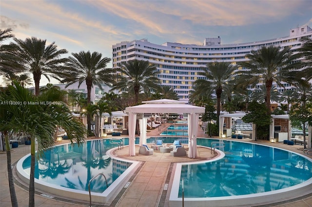 pool at dusk with a patio