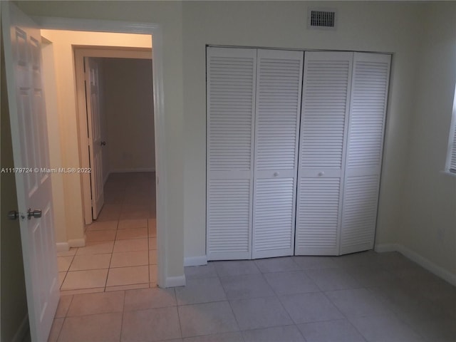 hall featuring light tile patterned flooring