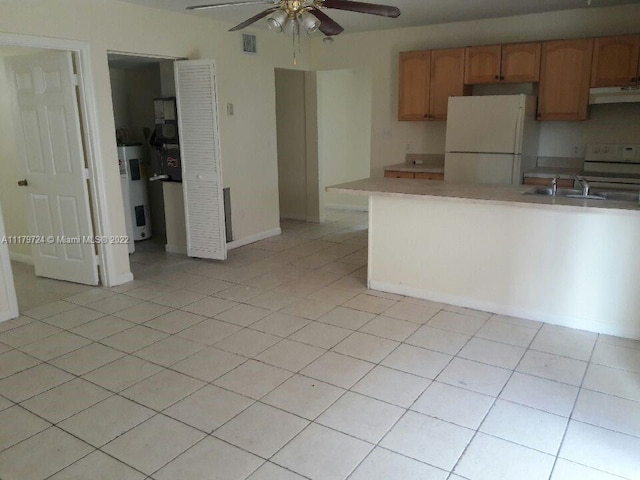 kitchen with stove, white refrigerator, ceiling fan, range hood, and water heater