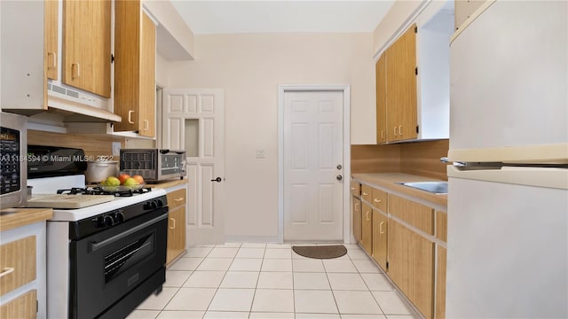 kitchen featuring white appliances and light tile flooring