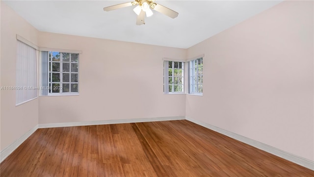 empty room featuring ceiling fan and hardwood / wood-style flooring