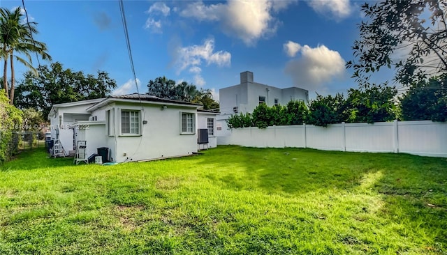 rear view of property with a lawn