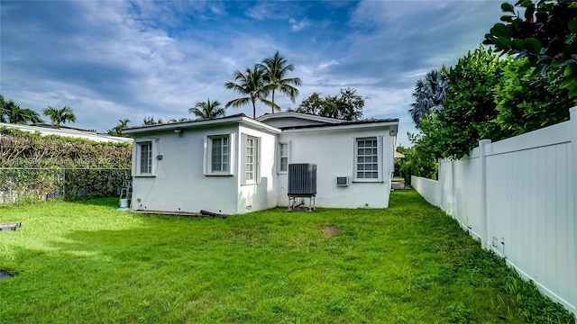 rear view of property featuring a yard