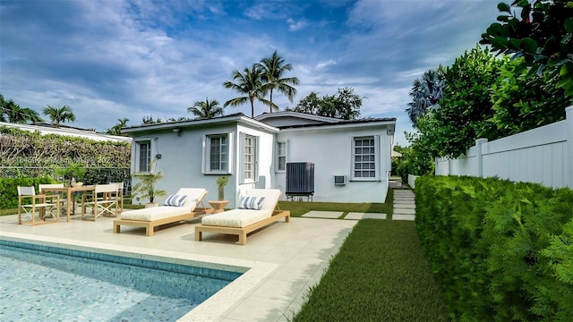 back of property with a lawn and a patio area