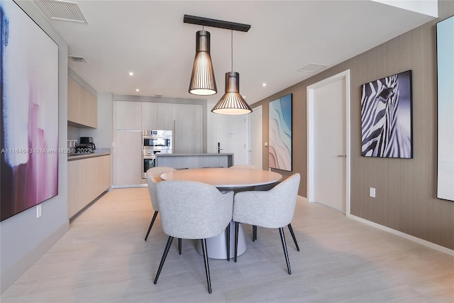 dining space with light wood-type flooring