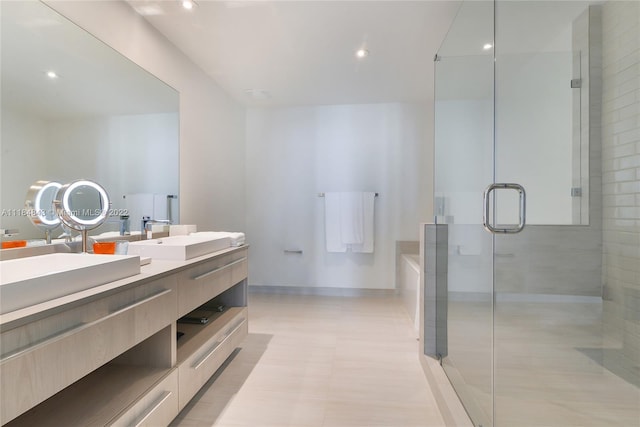 bathroom with double vanity and an enclosed shower