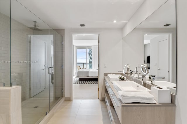 bathroom with a shower with door, tile flooring, dual sinks, and large vanity