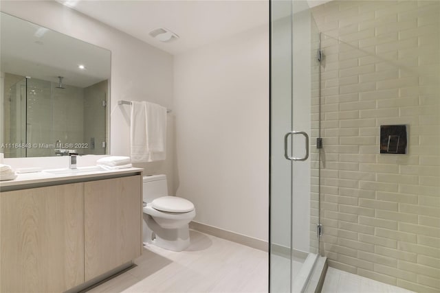 bathroom with an enclosed shower, toilet, vanity, and tile flooring