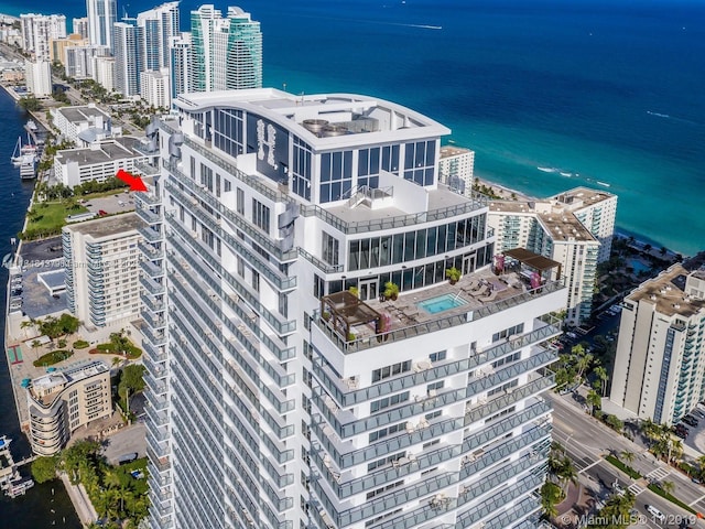 birds eye view of property with a water view